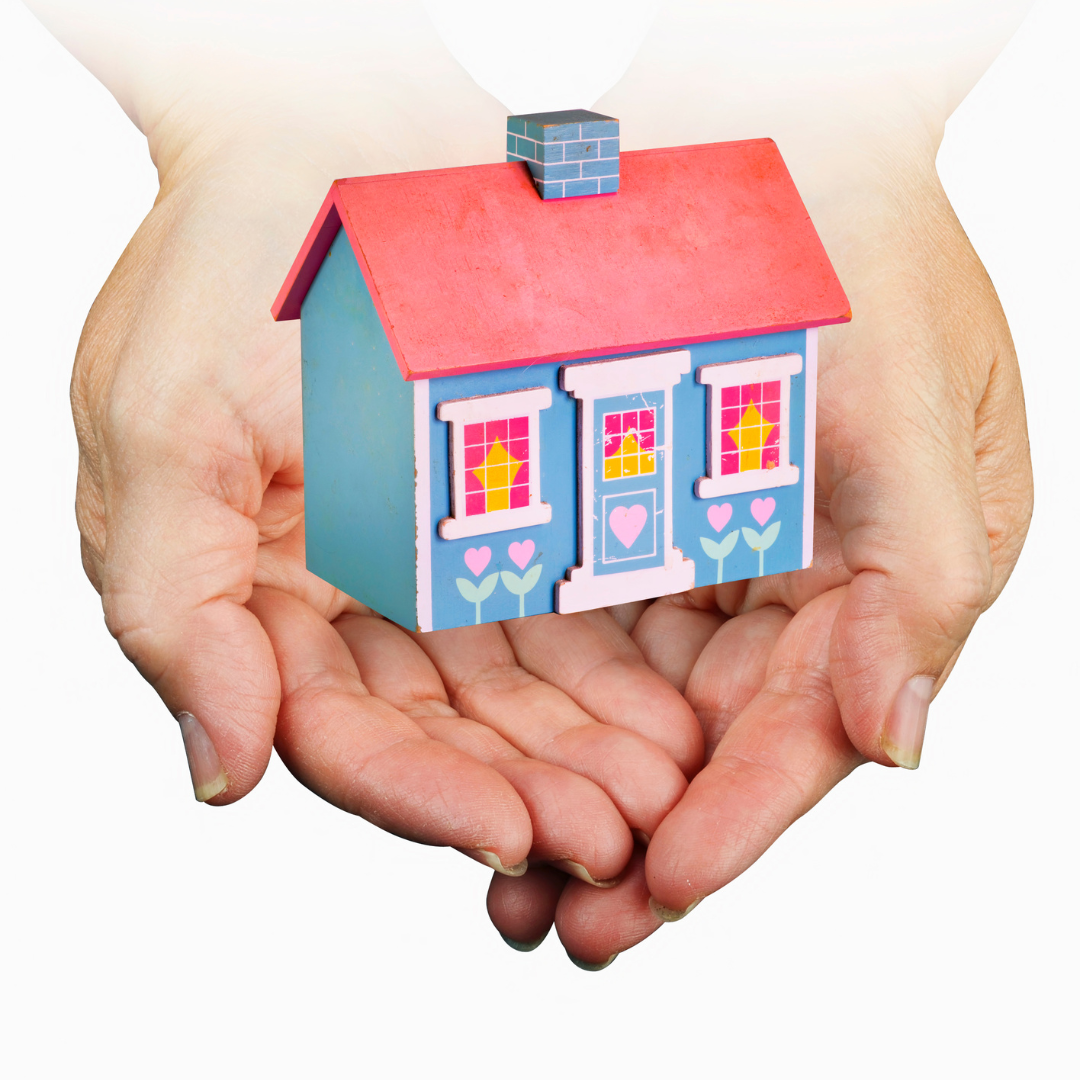 Image of a house cradled in hands for the benefits of home ownership blog